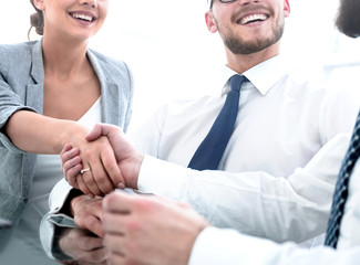 background image.handshakes colleagues at the Desk