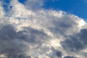 Obraz premium Large white cumulus clouds on a blue sky for background or ecology or nature.