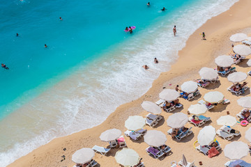 Sea waves and beach with sun umbrellas, aeral view, Kaputash beach