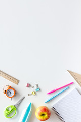 Education concept with stationery of student with notebook, pens, clock on white background top view mockup
