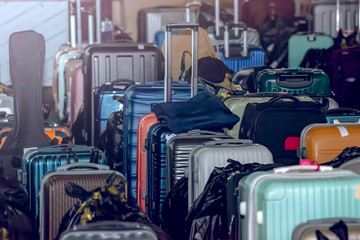 Travelers' suitcases waiting to be loaded into the luggage compartment