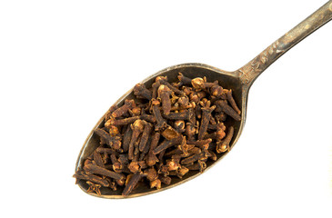 Dry cloves in a spoon isolated on a white background. Spice on isolate. View from above.