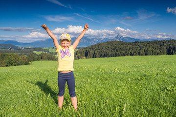 Germany, Bavaria, Allgaeu, happy girl cheering in the fields