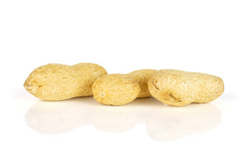 Group of three whole natural yellow peanut in row isolated on white background