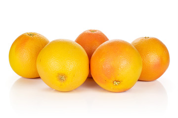 Group of five whole fresh pink grapefruit arranged symmetrically isolated on white background