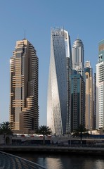Fototapeta na wymiar DUBAI, UAE - may 2019: View of modern skyscrapers shining in sunrise lights in Dubai Marina in Dubai, UAE.