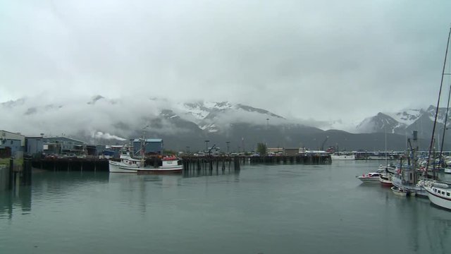 Seward Alaska fishing boat, pan around to marina
