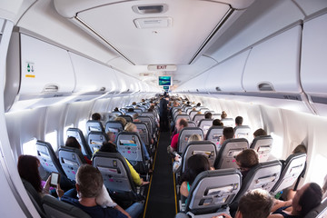 Inside view on passenger and cabin crew people on an airline airplane during flight  vacation....