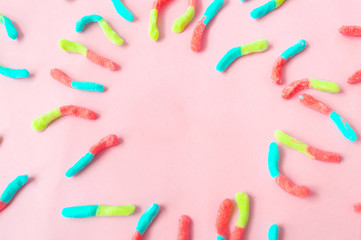 gomitas de diferentes  colores  sobre un fondo rosado
