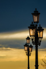Fototapeta na wymiar Old traditional Venice street lamps at sunset in a romantic and unique atmosphere (with copy space)