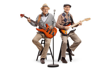 Two senior men sitting and playing electric guitars - Powered by Adobe