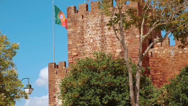 Close-up of the Castle of Silves, in The Algarve, Portugal, with its distinctive red sandstone and history dating back to 201 BC