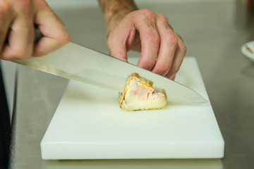 chef filleting a delicious piece tuna with his special knife