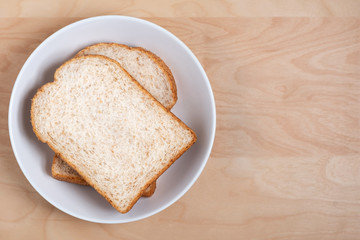 Top view of sliced bread on wood table background