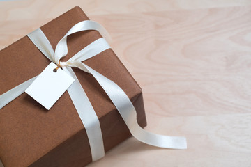 Gift Box on wood talbe with blank card, copy space