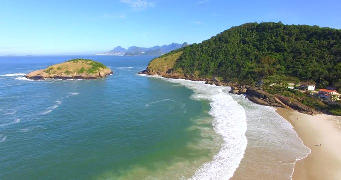Beautiful beaches of fine white sand. View from the top of Piratininga beach in Niteroi, with the Rio de Janeiro city hills in the background, including Sugar Loaf Mountain and Corcovado. 
