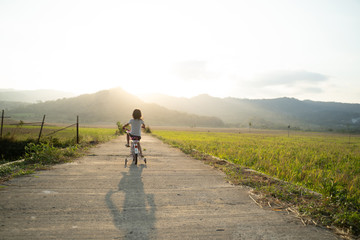Fototapeta premium toddler enjoy riding her bicycle outdoor in beautiful day