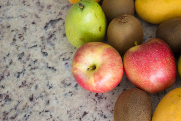 Fruits (kiwi, apple and pears) on a table