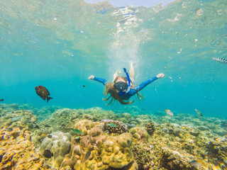 Obraz na płótnie Canvas Happy woman in snorkeling mask dive underwater with tropical fishes in coral reef sea pool. Travel lifestyle, water sport outdoor adventure, swimming lessons on summer beach holiday
