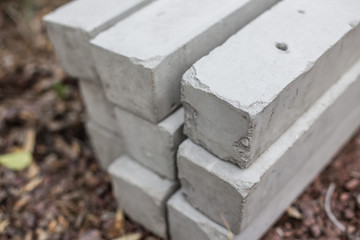 Pile of concrete poles on blurred background