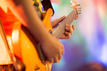 musicians are playing electric guitar on the stage