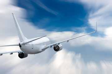 Fototapeta na wymiar White airplane flying above cloud at daytime