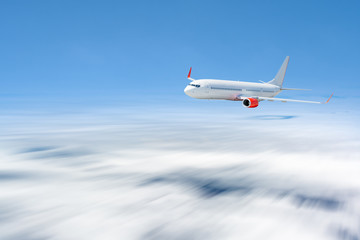 Fototapeta na wymiar White airplane flying above cloud at daytime with motion blur effect