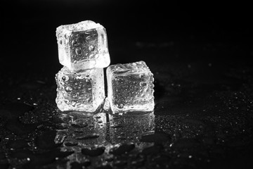 ice cubes on black table background.