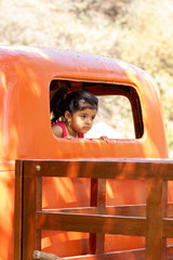 Little girl playing to drive cargo truck