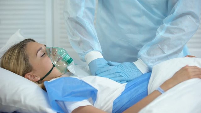 Doctor making cardiopulmonary resuscitation to female patient, reanimation