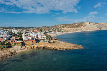 Fort and beautiful beach, Praia da Luz, Algarve, Portugal, summer aerial drone wide view
