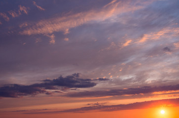 Fototapeta na wymiar Dawn orange sun in dramatic clouds in the early morning.