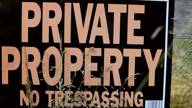 Private Property sign posted on fence to stop people from entering area.