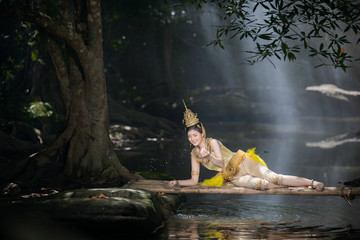 Beautiful asian woman in KINNARY costume thailand art concept playing water