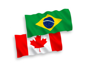 National vector fabric wave flags of Canada and Brazil isolated on white background. 1 to 2 proportion.