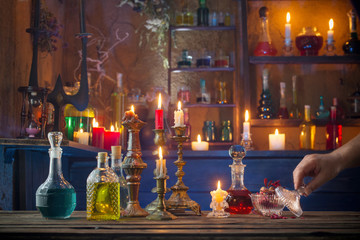 magic potions in bottles on wooden background