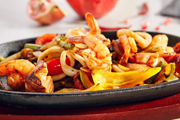 Wok with grilled vegetables, tiger shrimps or prawns and squid rings