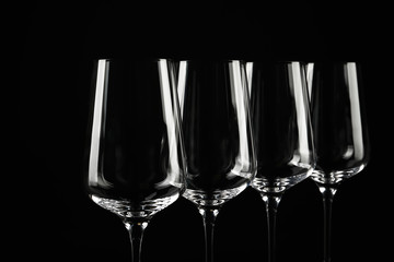 Set of empty wine glasses on black background