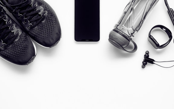 Fit health lifestyle and weight lose diet background concept. Fitness equipment running shoes,water bottle, smartwatch,smartphone, earphone on white.
