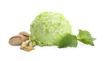 Scoop of delicious pistachio ice cream with mint and nuts on white background