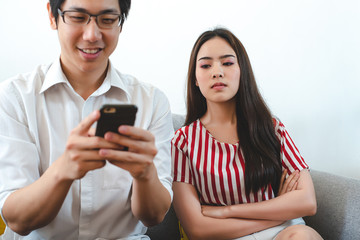 A girl was peeping at a young man who was chatting with someone. Relationship problems and divorce.