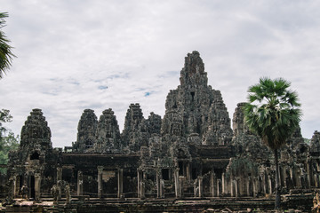 Fototapeta na wymiar Beautiful and gigantic ruined Bayon temple in Ankgor Thom, Cambodia - UNESCO World Heritage Site 1992