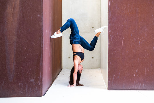 Young woman doing handstand yoga