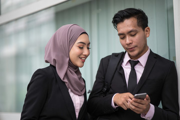 A business asian man showing some information to her business partner