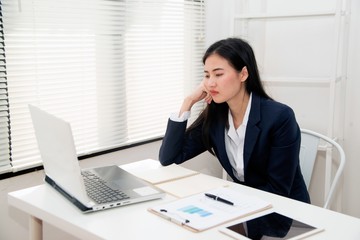 Asian Young beautiful business woman suffering stress working at office from feeling tired and desperate looking overworked and   overwhelmed and frustrated. .