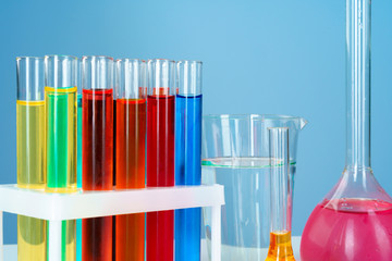 Chemical laboratory glassware with various colored liquids  on table