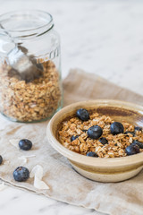 bowl of granola cereal with blueberries
