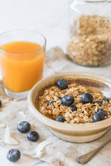 bowl of granola cereal with blueberries and juice healthy breakfast