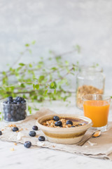 Healthy breakfast with granola cereals, blueberry and orange juice