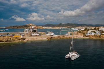 Aerial view on catamaran and port on the background.